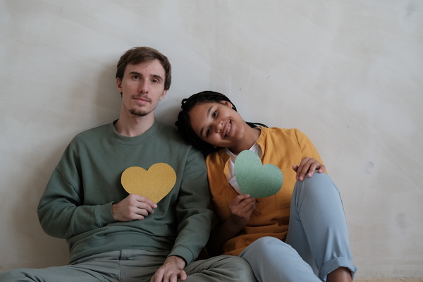 Man and Woman Holds Heart-Shaped Cards